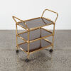 An Anodised Brass And Woodgrain Formica Trolley - 2