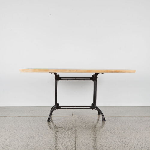 A Solid Slab Dining Table With Black Metal Base