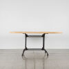 A Solid Slab Dining Table With Black Metal Base