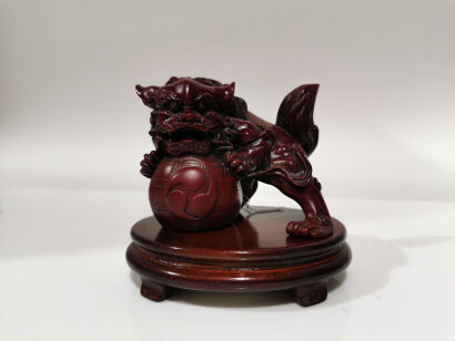 A Chinese Resin Carving of Lion on Wooden Stand