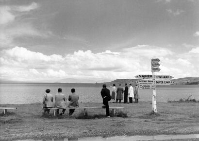 UNKNOWN PHOTOGRAPHER Signpost and visitors at Lake Taupo