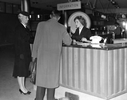 J. AMBROSE Airport hostess Monya Bennett (left) and information receptionist Rosalind Wilson assist a traveler