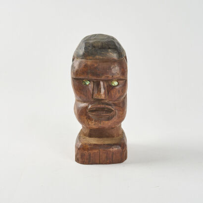 A Carved Bust With Paua