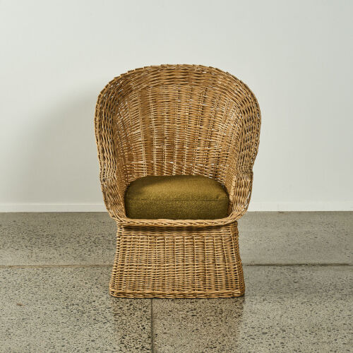 A Mid Century Wicker Chair With Boucle Cushion