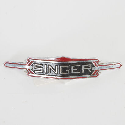 A Vintage Singer Car Badge