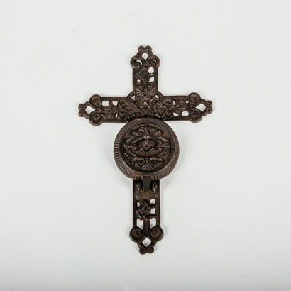 A Cast Iron Cross With Candle Holder