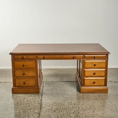 A Wooden Pedestal Desk With Drawers