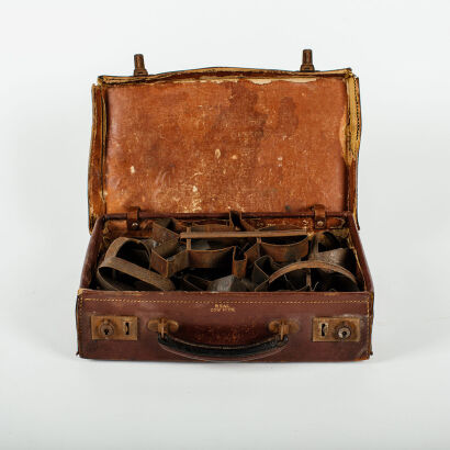 A Vintage Leather Suitcase Of Cookie Cutters