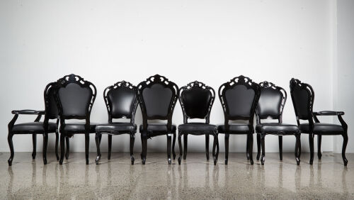 A Suit Of Eight Louis Black Lacquer And Leather Dining Chairs
