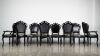 A Suit Of Eight Louis Black Lacquer And Leather Dining Chairs