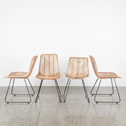 A Set Of Four Cane Dining Chairs With Black Metal Sleigh Base