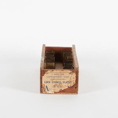 An Antique Box Of Brass Letter Stencils