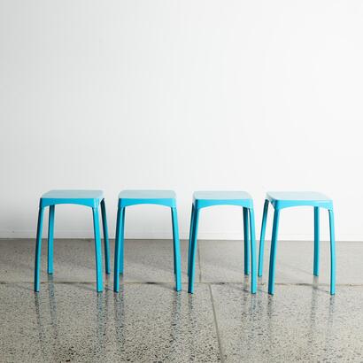 A Set Of Four Blue Stacking Stools