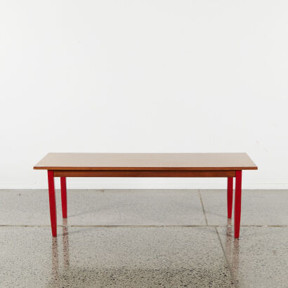 A Mid-Century Coffee Table With Red Legs