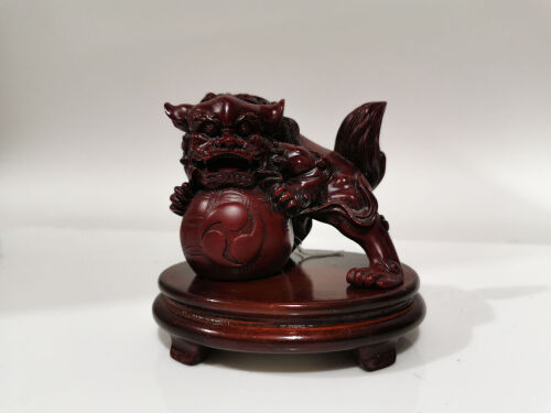 A Chinese Resin Carving of Lion on Wooden Stand