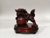 A Chinese Resin Carving of Lion on Wooden Stand