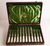 A Cased-Set of Twelve Silver and Mother-Of-Pearl Fruit Knives and Forks