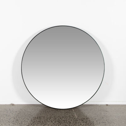 A Large Circular Wall Hanging Mirror