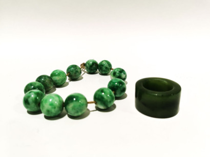 A Chinese Jadeite Bracelet and A Chinese Jade Thumb Rings