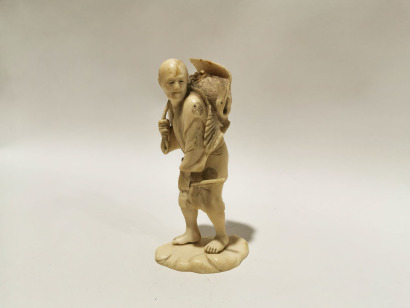 A Japanese Ivory Carving of a Farmer and Crane