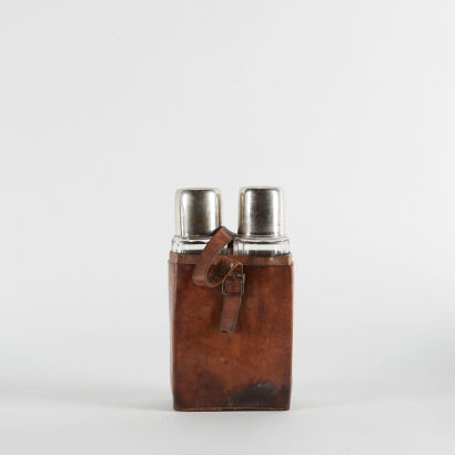 A Vintage Travel Bottles With A Leather Holster