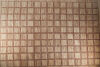 A Large Rug with Brown and Red Squares