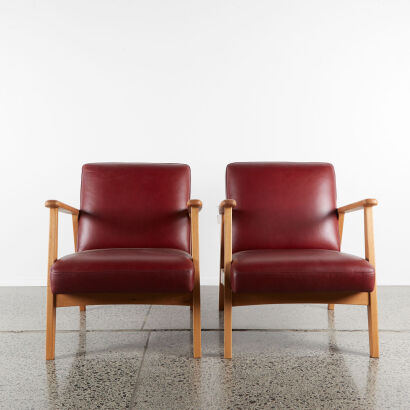 A Pair of Red Leather Armchairs