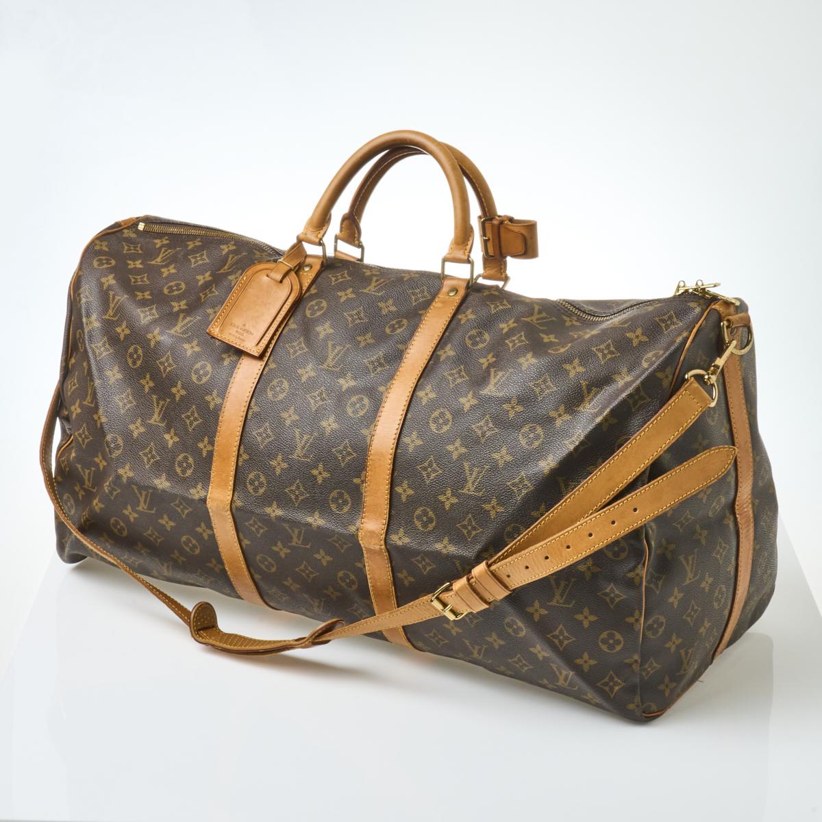 Louis Vuitton, A Louis Vuitton Keepall leather travel bag with luggage tag  width 13cm
