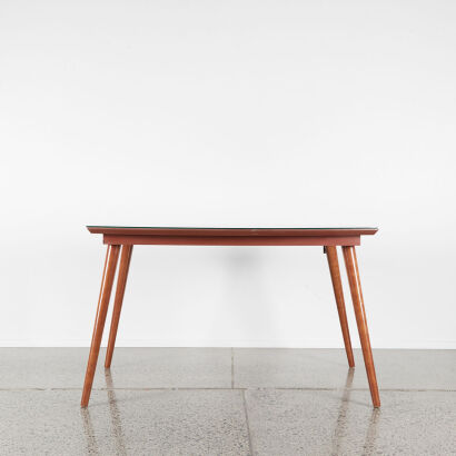 A Mid-Century Dining Table With A Glass Overlay