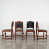 A Set Of Four English Oak And Leather Chairs