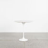 A Tulip Side Table With White Base And Marble Top