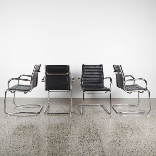 A Set Of Four Black Leather And Chrome Cantilever Chairs