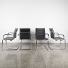 A Set Of Four Black Leather And Chrome Cantilever Chairs