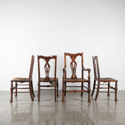 A Set Of Four Arts And Crafts Chairs Including One Carver