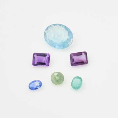 A Collection of Loose Gemstones - Amethyst, Aquamarine, Demantoid Garnet, Emerald and Sapphire