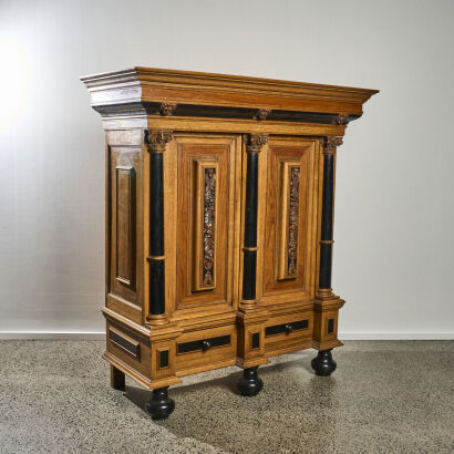 A Swedish Baroque Revival Carved Oak and Ebonised Court Cupboard