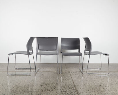 A Set Of Four Freeway Stackable Chairs In Grey With Chrome Sleigh Base