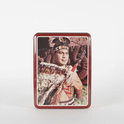 A Bycroft Biscuit Assortment Tin with Tiki Motifs around all sides and Maori warrior with Taiaha on Lid