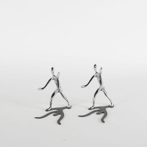 Two Chrome Figures With Shadows