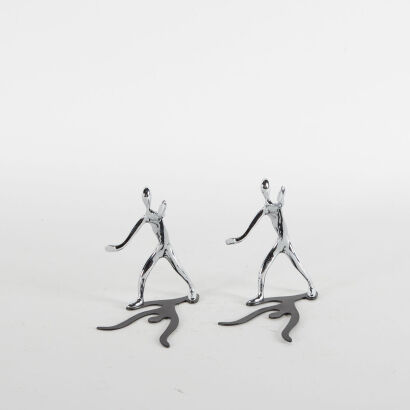 Two Chrome Figures With Shadows