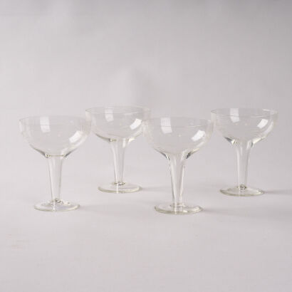 A Set Of Four Etched Hollow Stem Champagne Coupes