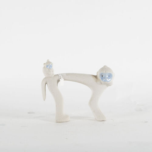 A Porcelain Monkey Figurine With White Snow Glaze