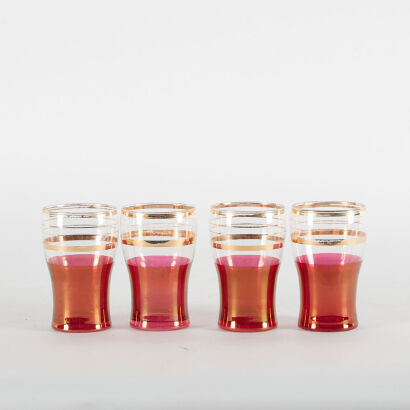 A Collection Of Four Magenta And Gold Coloured Glasses