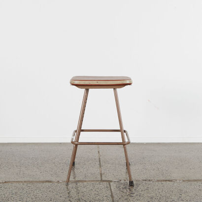 A Vintage Industrial Metal Stool with brown vinyl cover