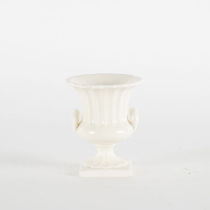 A Small Ceramic Urn With Handles