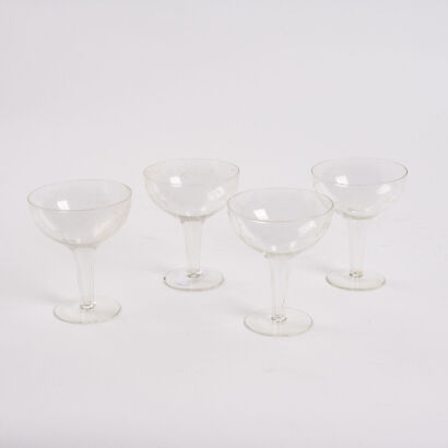 A Set Of Four Etched Hollow Stem Champagne Coupes