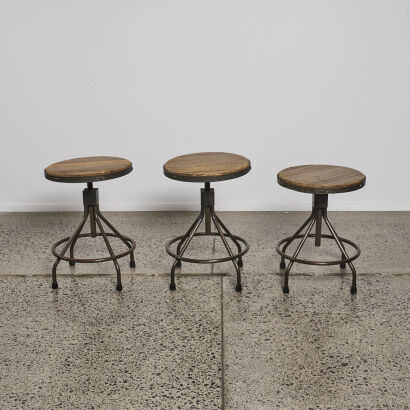 A Set Of Three Industrial Stools