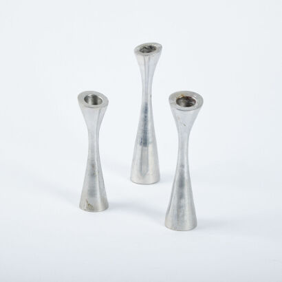 A Trio Of Cast Aluminium Candle Stick Holders