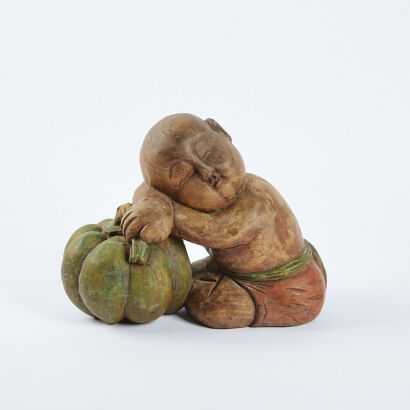 A Hardwood Carving Of A Baby Buddha