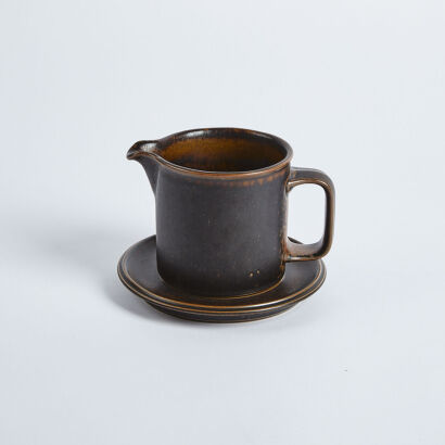 An Arabia Ceramic Jug And Saucer From Finland